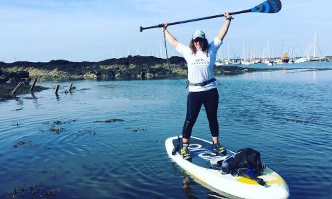 A visibly stoked Sian Sykes after finishing her circumnavigation of Anglesey. | Photo via: Sian Sykes