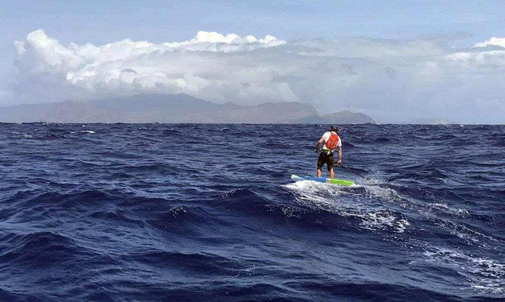 Travis Grant paddling towards Oahu in the distance. | Photo: Blair Grant