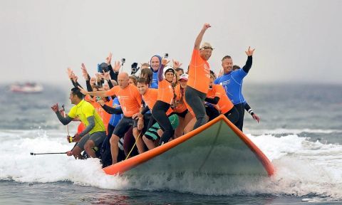 A new record was set in Huntington Beach, California for most people to ride one surfboard. | Photo Courtesy: OC Register / MINDY SCHAUER