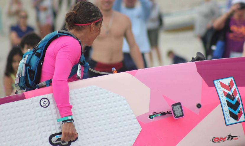 Champion paddler Annabel Anderson carrying her board up the beach with ease, courtesy of the LiftSUP handle. | Photo: Onit.Pro